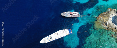 Aerial drone ultra wide photo of sailing yacht docked in paradise turquoise sea exotic island destination