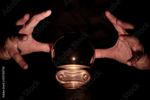 Slika na platnu Hands over crystal ball in dark room, crystal ball gazing, crystal ball psychic,