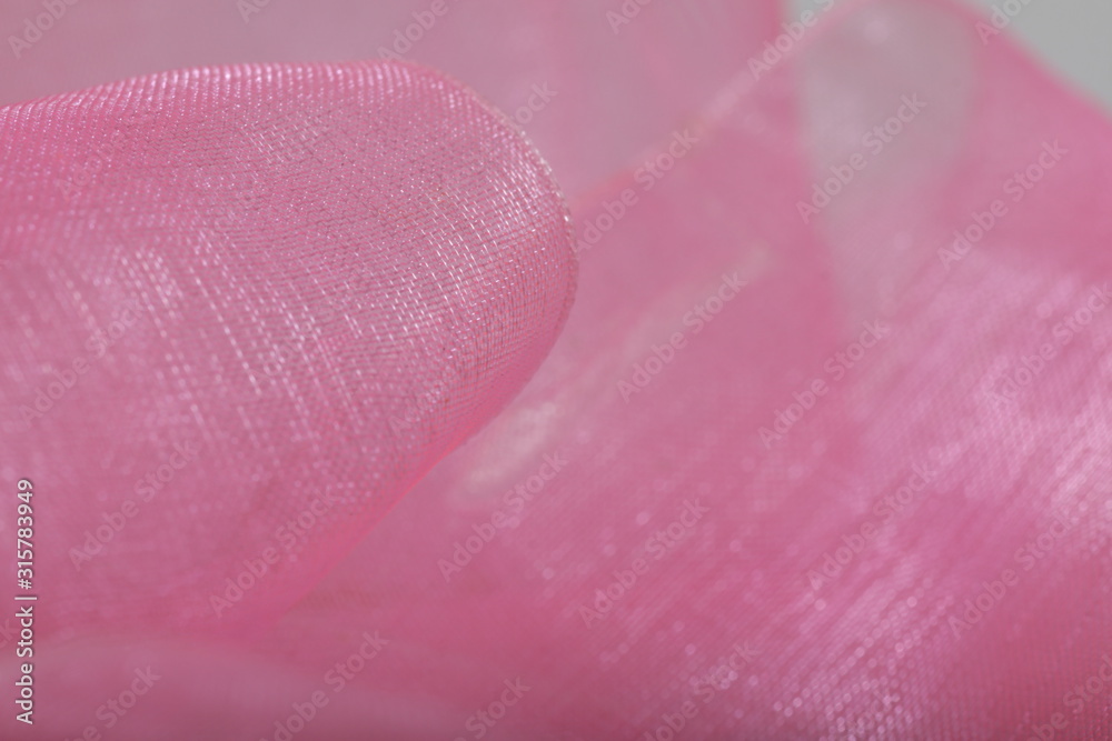 Fototapeta premium Pink satin ribbon texture for background / wallpaper