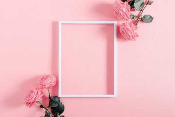 Beautiful flowers composition. Blank frame for text, pink rose flowers on pastel pink background. Valentines Day, Easter, Birthday, Happy Women's Day, Mother's day. Flat lay, top view, copy space