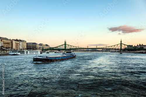 Freighter Riverboat Sails Under the Liberty Bridge in Budapest, Hungary.