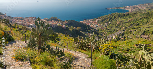 Taormina - The path among the spring mediterranean flowers and cactus - Sicily.