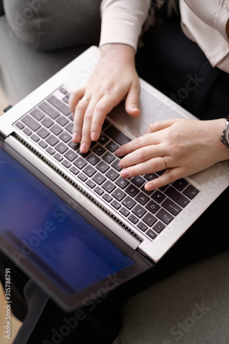 Woman is typing on a laptop. Communication and business affairs