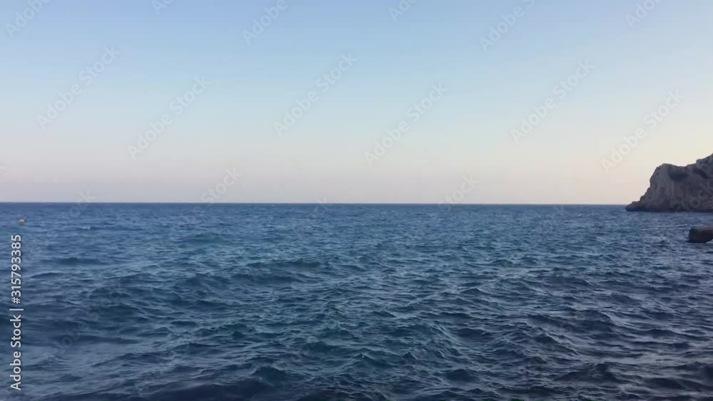 Blue sea waves seen from the beach. Mediterranean Sea, Spain Blue sea waves seen from the beach. Mediterranean Sea, Spain