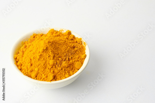 Dry turmeric powder isolated on white background.Close-up of powder orange color turmeric.top view