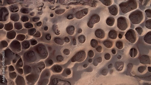 Close up shot of tafoni formations in a clay pan in Namibia.