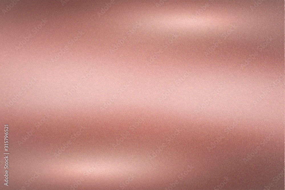 Brushed rose gold metallic wall with scratched surface, abstract texture background