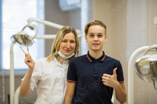 Patient guy and dentist woman  portrait in dental room. .