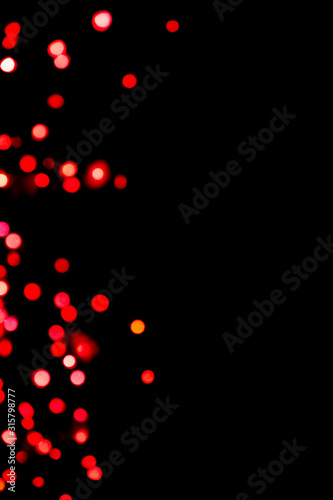 Black background with bright red warm bokeh lights. Holiday, Valentines, Christmas and New Year background. Ideal to layer with any design. Horizontal