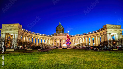 Night view of russian orthodox church Kazan Cathedral with New Year's fir-tree at snowless winter on Nevsky Prospect. Saint-Petersburg, Russia.