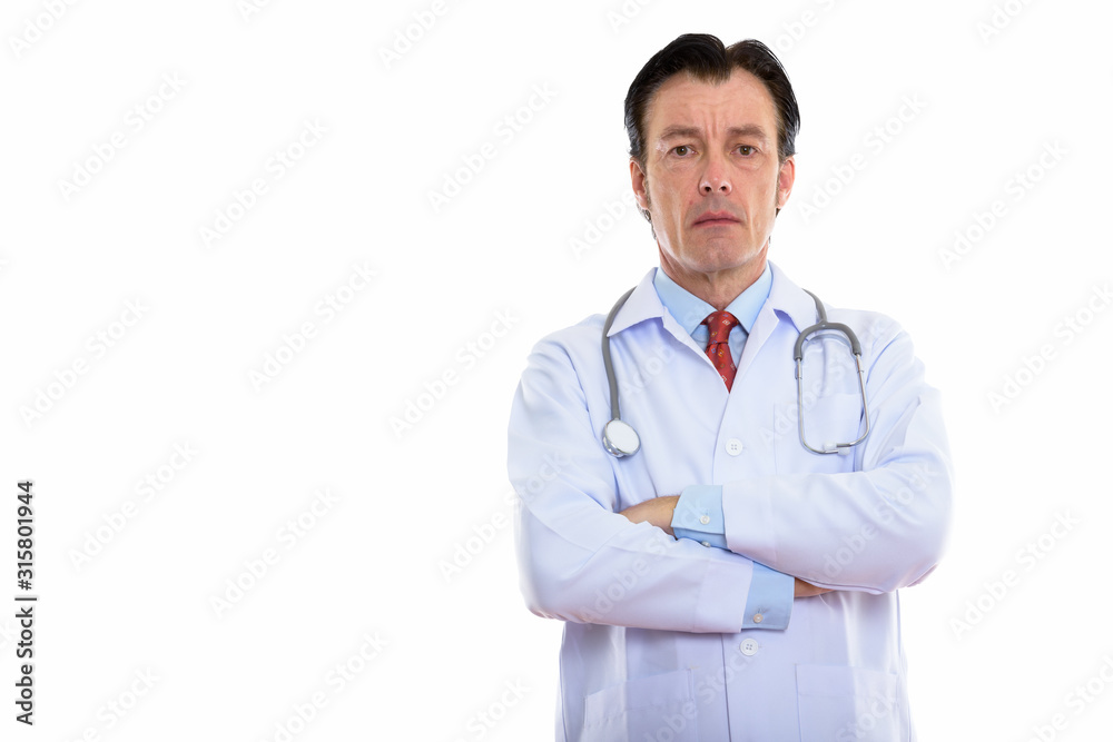 Studio shot of mature handsome man doctor with arms crossed Studio shot of mature handsome man doctor with arms crossed