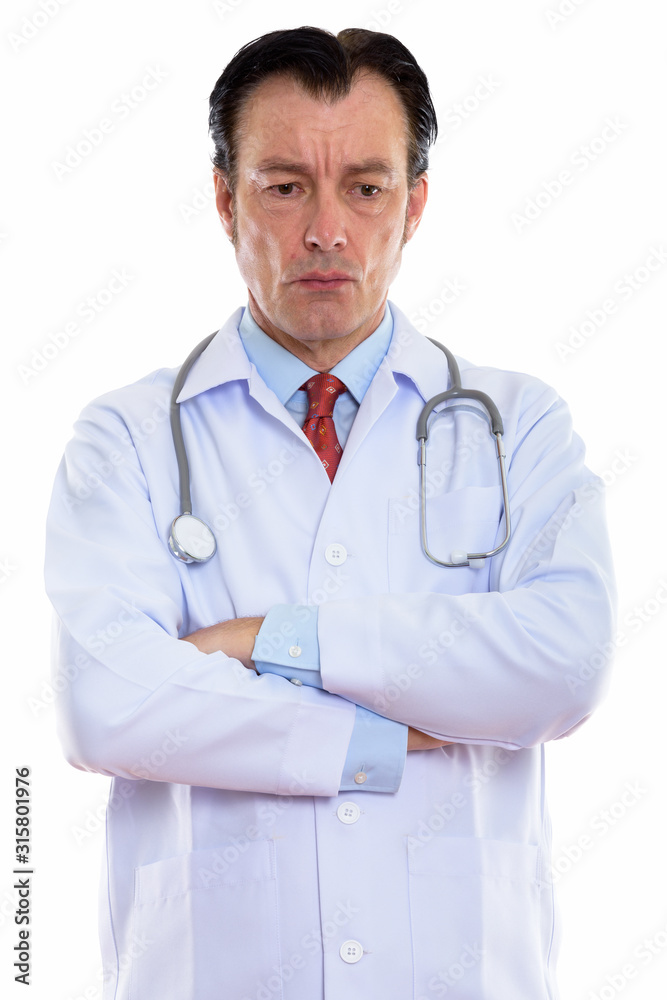 Studio shot of mature handsome man doctor thinking while looking down Studio shot of mature handsome man doctor thinking while looking down