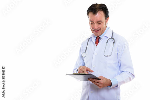 Portrait of happy mature handsome man doctor reading on clipboard