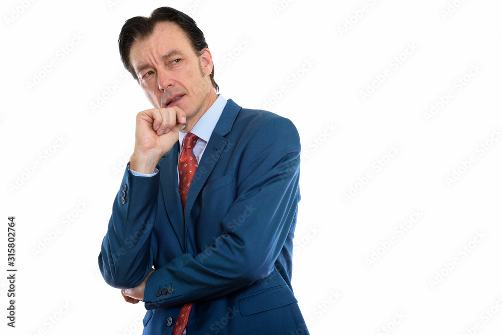 Studio shot of mature angry businessman thinking Studio shot of mature angry businessman thinking