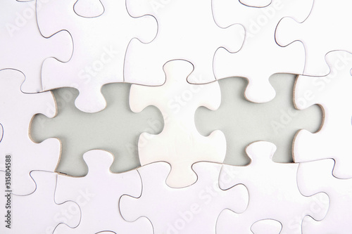 Magnifying glass searching missing puzzle.