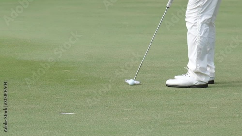 Professional golfer started a game golf. Golfer taking shot on the golf course.