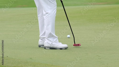 Professional golfer started a game golf. Golfer taking shot on the golf course.