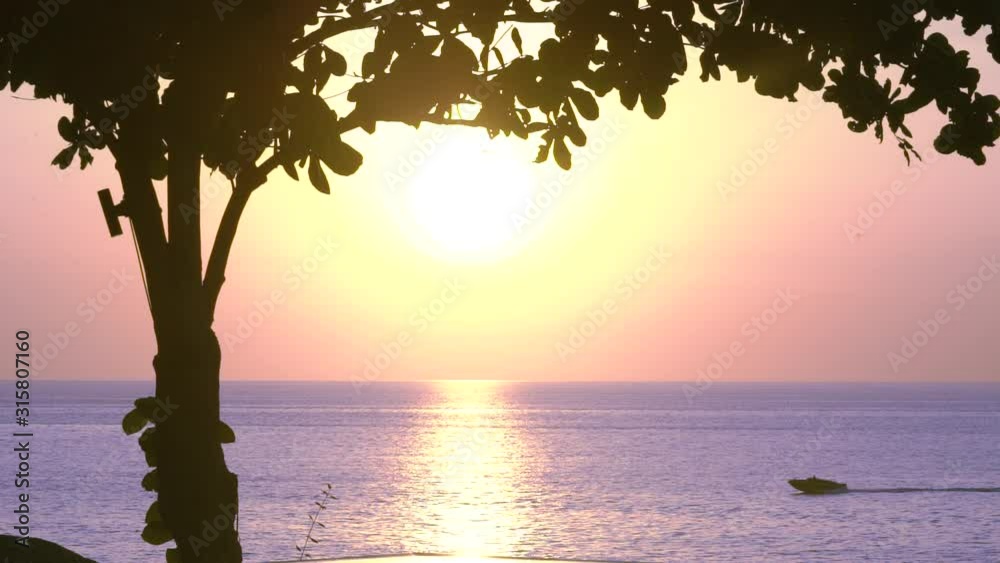 Fantastic sunset on the island of Phuket, Thailand, mixed orange yellow pink blue colors by nature, the sky is painted, travel across Thailand, unique views from famous cafes, a boat floats by. Sunset Fantastic sunset on the island of Phuket, Thailand, mixed orange yellow pink blue colors by nature, the sky is painted, travel across Thailand, unique views from famous cafes, a boat floats by. Sunset