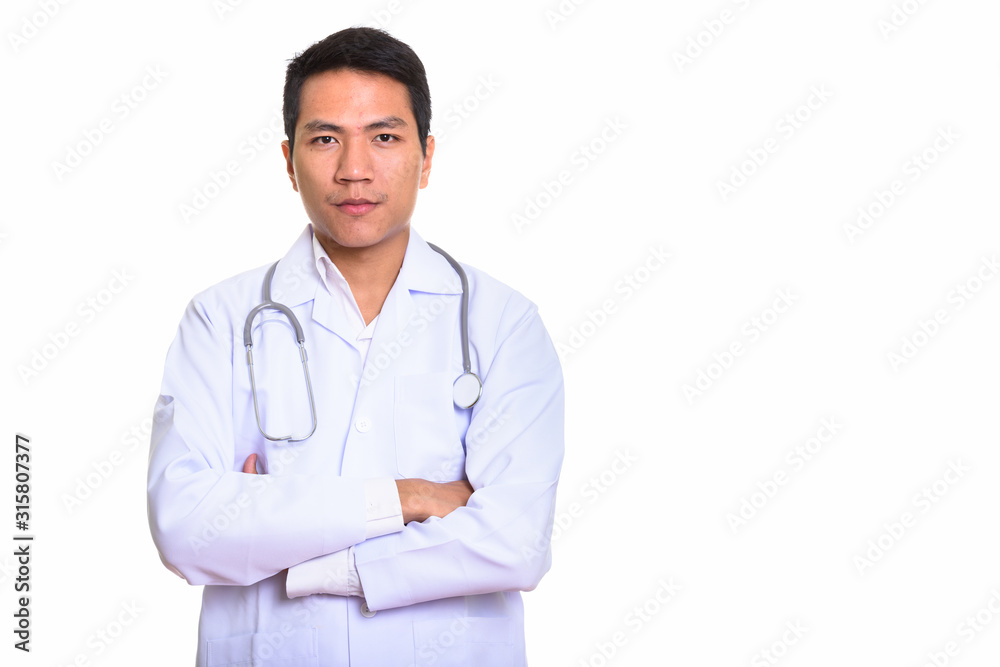 Studio shot of young Asian doctor with arms crossed
