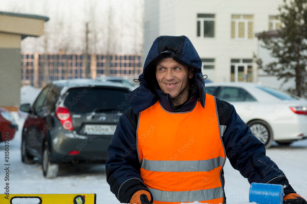 Portrait of installer in orange reflective vest