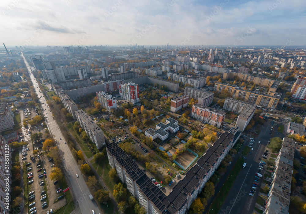 Aerial view of Ekaterinburg city. District of the city - Elmash. Autumn, sunny. Yellow leaves on trees