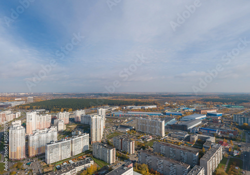 Aerial view of Ekaterinburg city. District of the city - Elmash. Autumn, sunny. Yellow leaves on trees