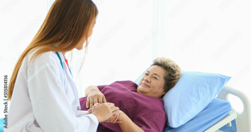 Doctor meeting and explaining medication to old woman patient at Hospitals
