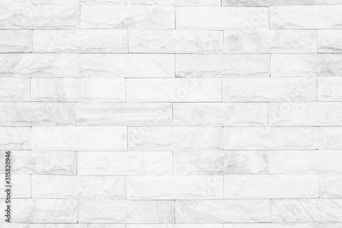Medieval natural stone wall texture background or boundary the rock seamless abstract and decor fragment of design vintage wallpaper pattern chipped ancient from white color for interior copy space.