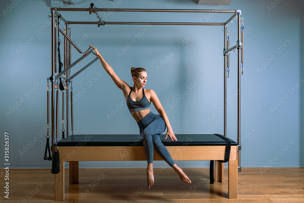 Pilates woman in reformer teaser exercise in gym indoors. Active lifestyle, body positive, beautiful color