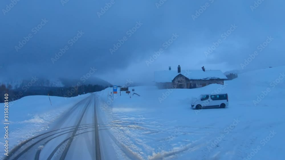 Car on a mountain road in winter, slippery road after a blizzard. 4k Car on a mountain road in winter, slippery road after a blizzard. 4k