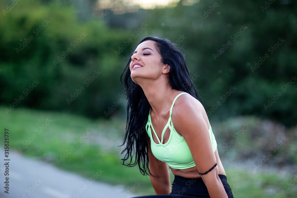 Young sexy fitness girl relax and pose after exercise on the park Young sexy fitness girl relax and pose after exercise on the park