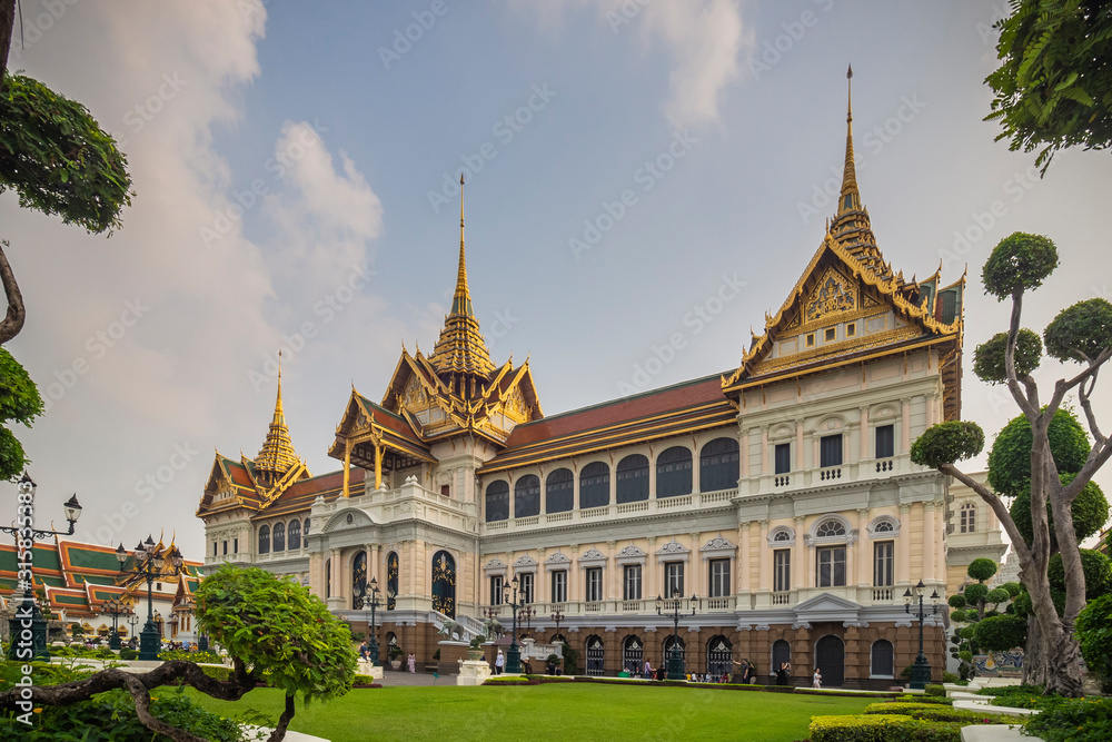 Tourists visiting The great and beautiful Chakkri Maha Prasat Throne Hall, The Grand Palace in Bangkok, Thailand.