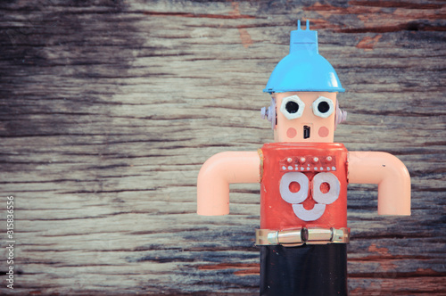 Assemblage daddy robot sculptures, wood background