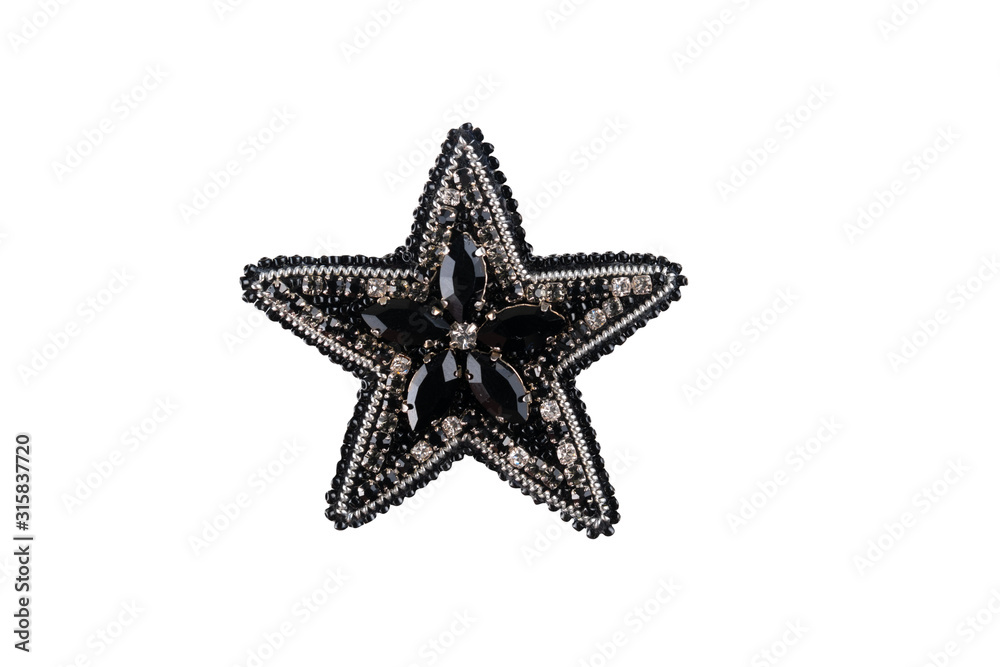 Obraz premium Brooch made of handmade colored beads on the background