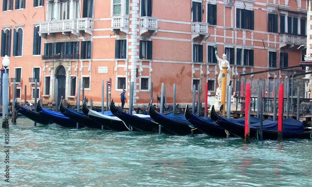 Venice, Italy, 28 December 2018 evocative image of gondolas moored along a pier