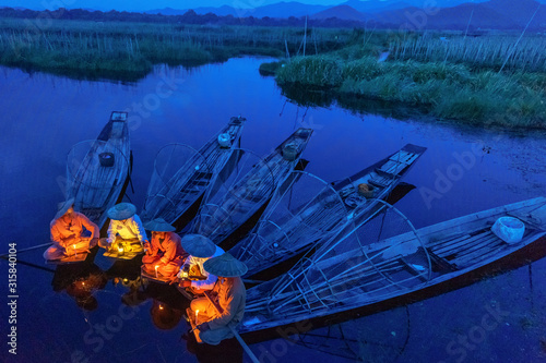 Intha fishermen working in the morning. Location of Inle lake, Myanmar. photo