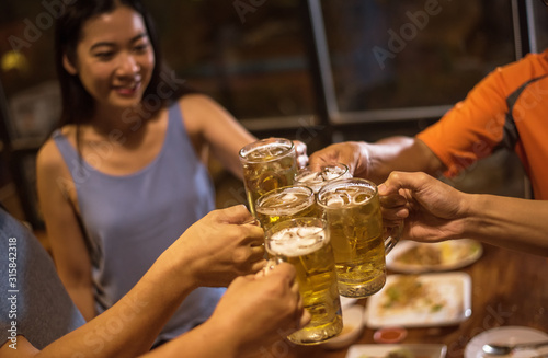 Group of friends drink beer during summer night