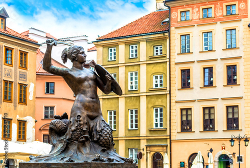 Sculpture in the old town in Warsaw on sunny day with blue cloudy sky.