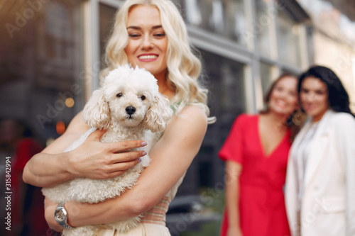 Women with cute dress. Three elegant woman in a city. Ladies in a stylish dress