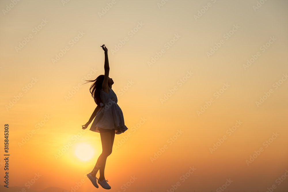 Fototapeta Young asia woman jumping in the sky and feeling free,happy