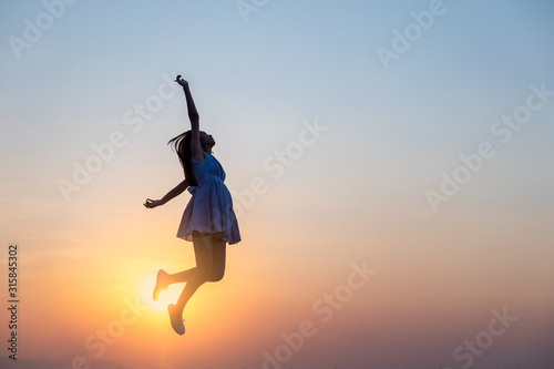 Young asia woman jumping in the sky and feeling free,happy