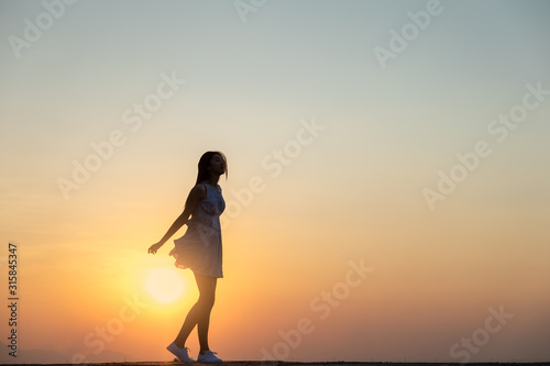 Young asia woman jumping in the sky and feeling free happy