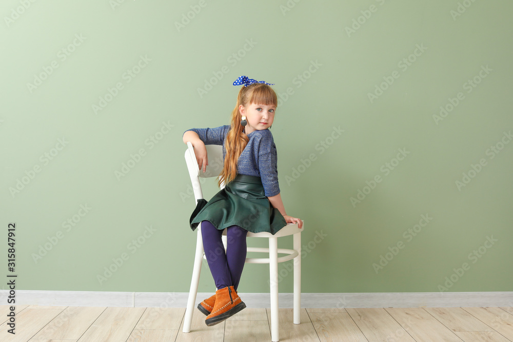 Cute fashionable girl on color background