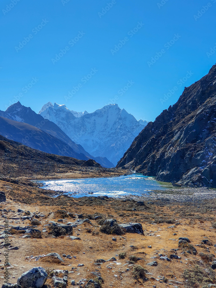 Taboche Tsho, second Gokyo lake. Everest base camp trek itinerary: from Machhermo to Gokyo. Beautiful views of autumn hills, snowy mountains and turquoise lakes.