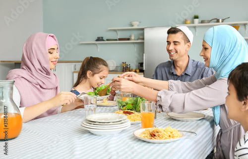 Muslim family having dinner at home photo