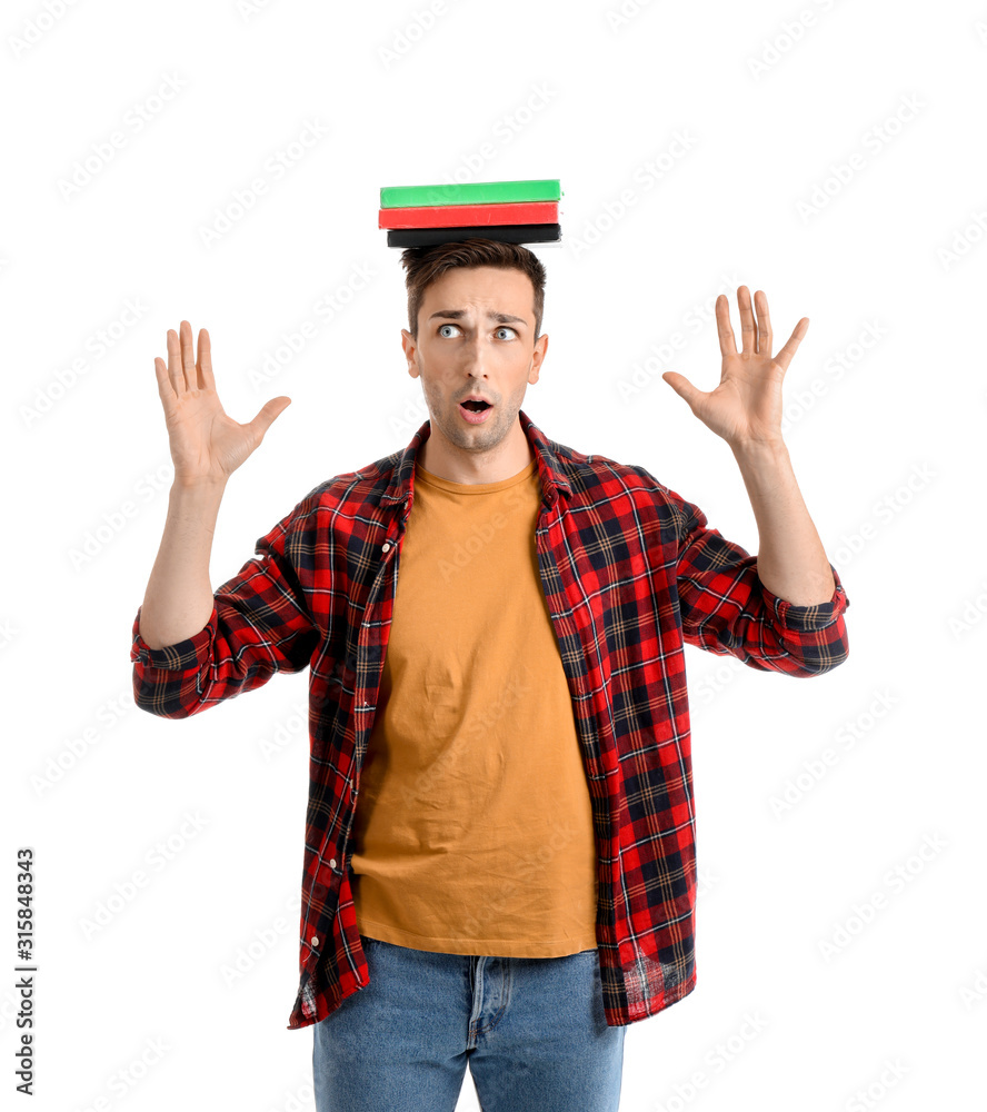 Worried young man with books on white background Worried young man with books on white background