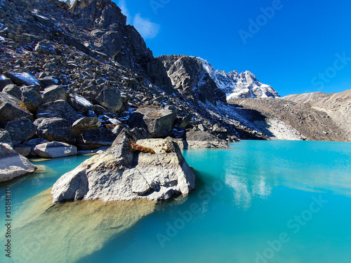 Dudh Pokhari, the third Gokyo lake. Everest base camp trek itinerary: from Machhermo to Gokyo. Beautiful views of autumn hills, snowy mountains and turquoise lakes. photo