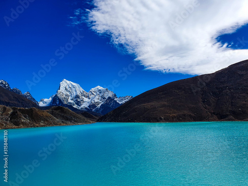 Everest base camp trek itinerary: Gokyo village, Solokhumbu, Nepal. Picturesque view on famous Dudh Pokhari or Gokyo lake with marvellous turquoise water. Cholatse peak. photo