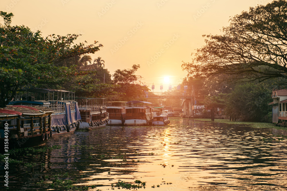 Fototapeta premium Alleppey backwaters with local boat on sunrise