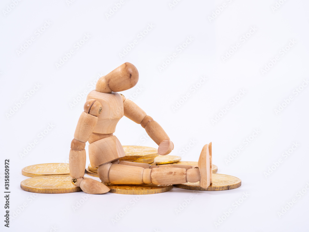 Wooden puppet Rolls of coins for finance and business concept Wooden puppet Rolls of coins for finance and business concept